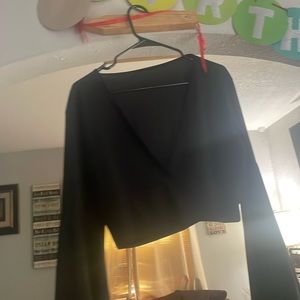 This is a black crop top with long, flustered sleeves from SHEIN .